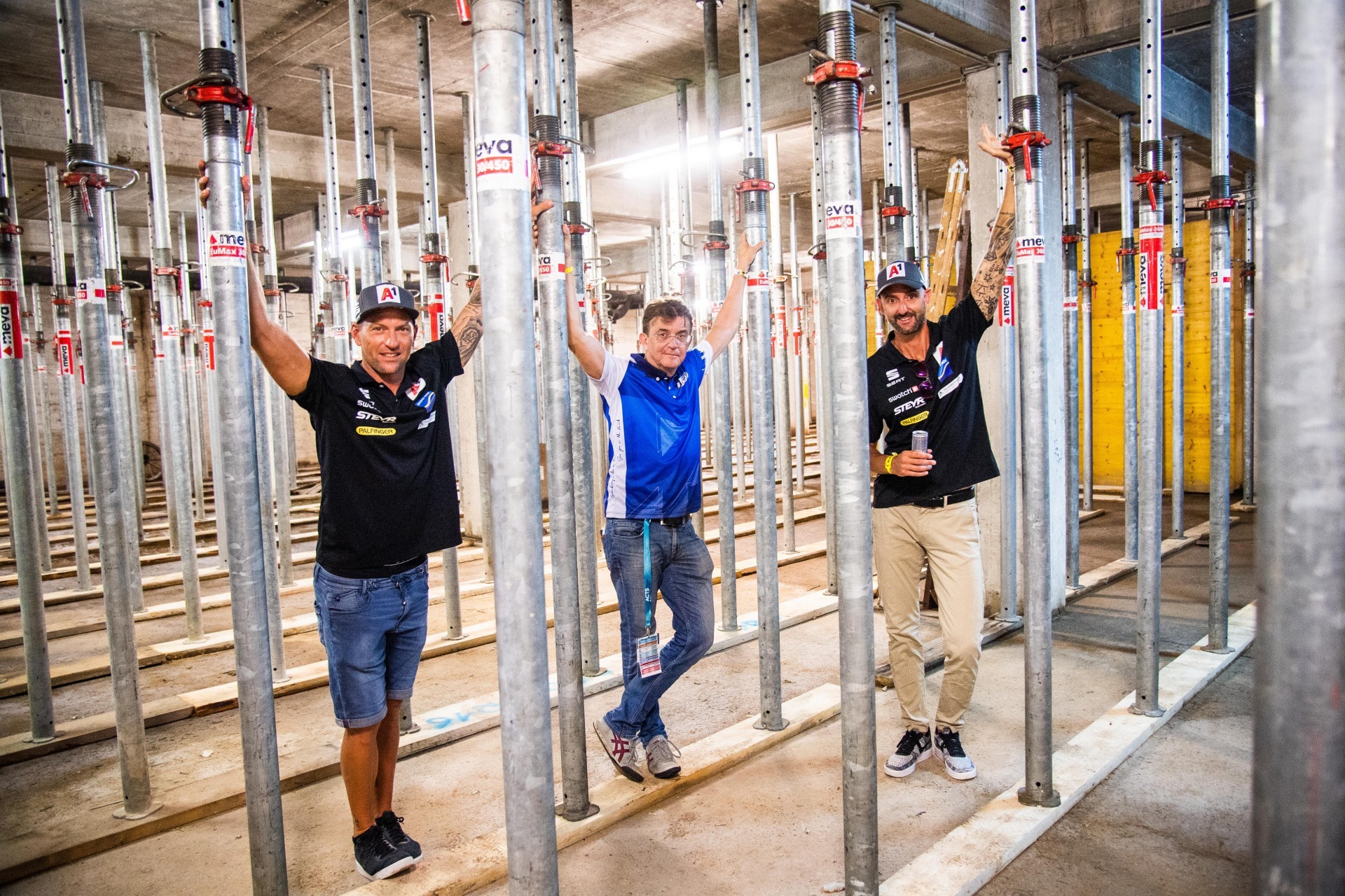 Horst, Jagerhofer and Doppler stand next to the steel poles that support the stadium