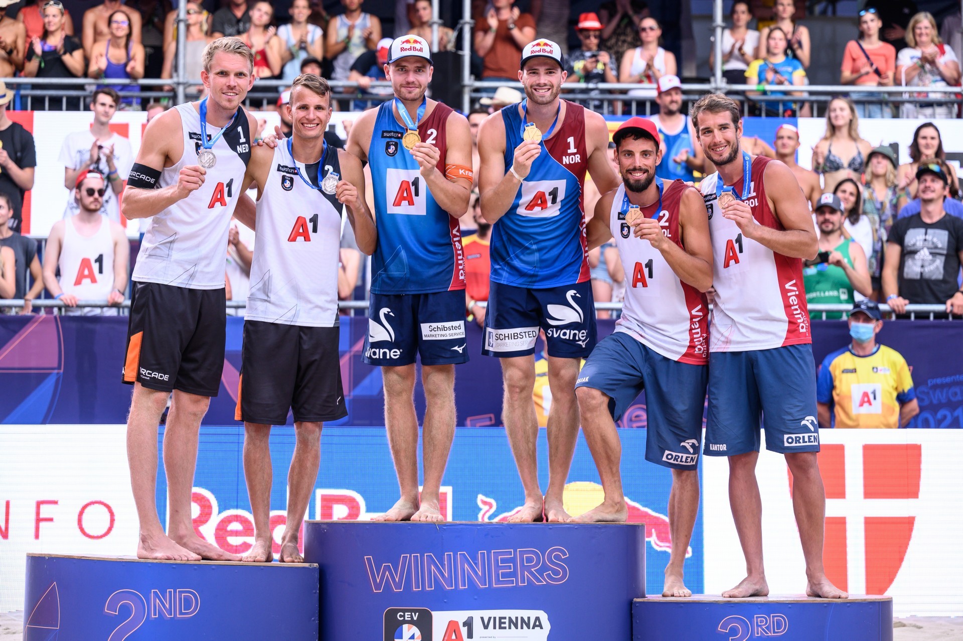 The medalists stand on the podium at the Red Bull Beach Arena